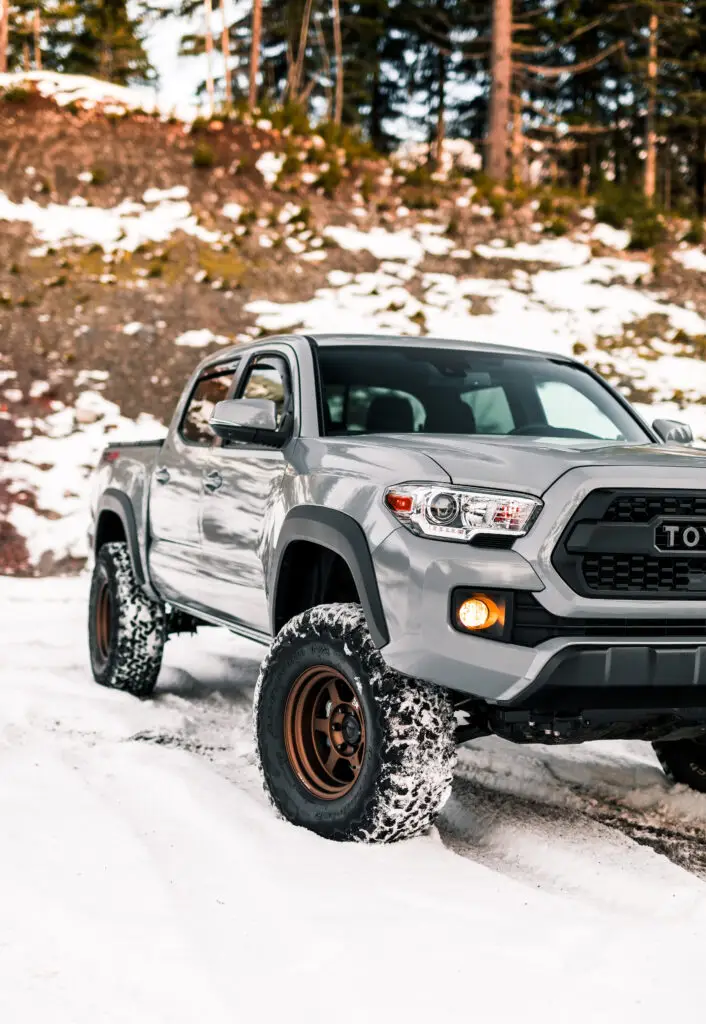 Pickup truck parked in snowy terrain, showing off-road capability and winter driving conditions